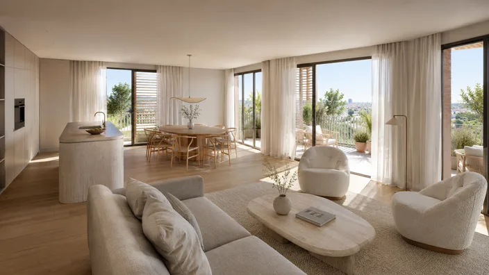 Open-plan living and dining room opening onto a terrace with views over Barcelona